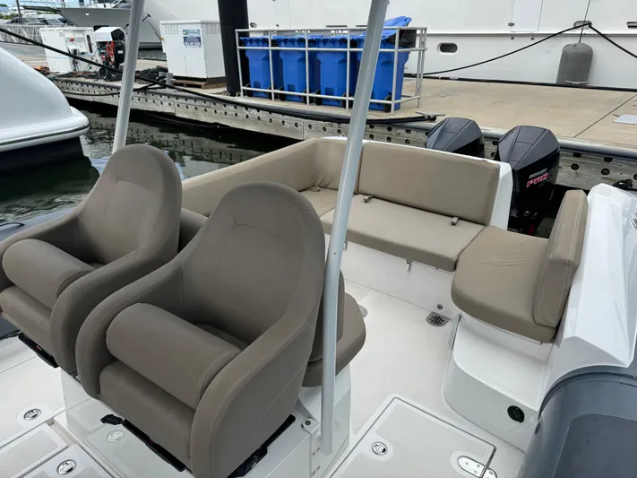  Yacht Photos Pics Luxury boat interior with beige seating, Iguana X100 model, docked at marina.