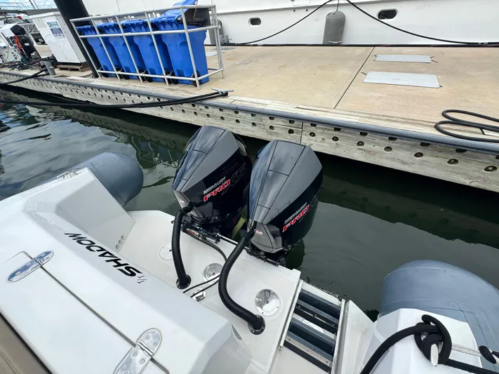  Yacht Photos Pics Twin outboard motors on a boat docked at a marina, Iguana X100, 2021 model.