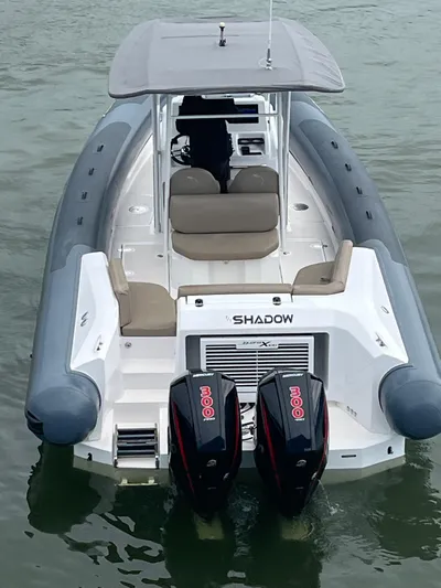  Yacht Photos Pics A 2021 Iguana X100 boat with dual engines on calm water.