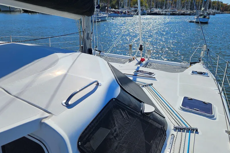  Yacht Photos Pics 2022 Seawind 1160 Lite catamaran on water, showcasing deck and marina background.
