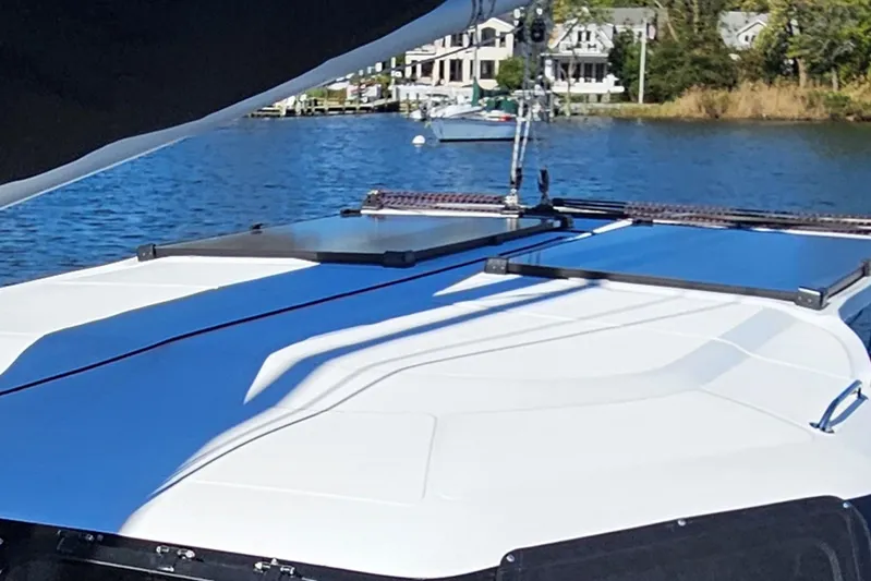  Yacht Photos Pics 2022 Seawind 1160 Lite catamaran on calm water, featuring sleek deck design.