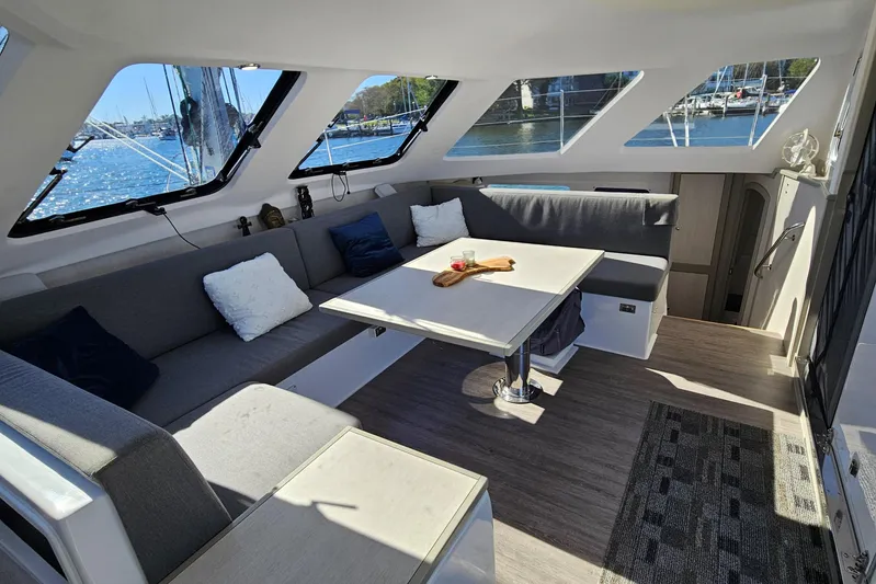  Yacht Photos Pics Interior of 2022 Seawind 1160 Lite catamaran with spacious seating and large windows.