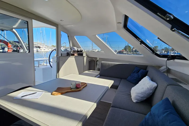  Yacht Photos Pics Interior of 2022 Seawind 1160 Lite catamaran with modern seating and marina view.