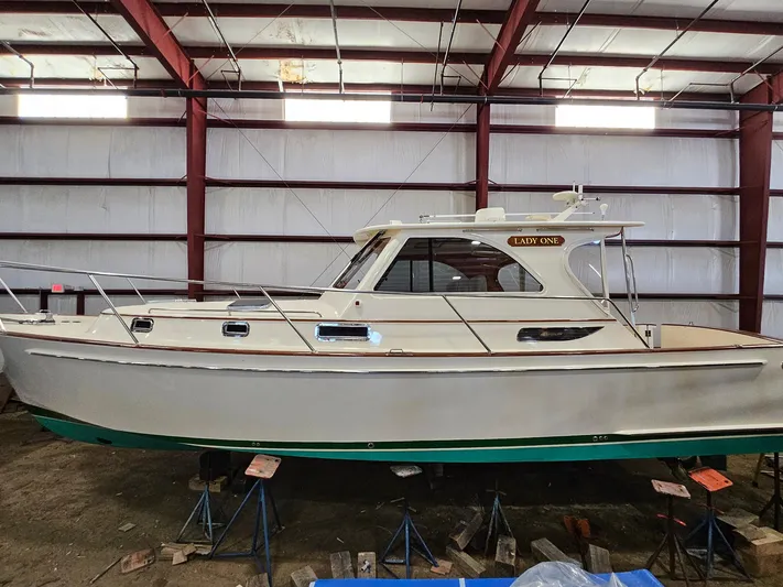 Lady One Yacht Photos Pics 2003 Legacy 40 Hardtop Express boat in storage, side view, indoors.