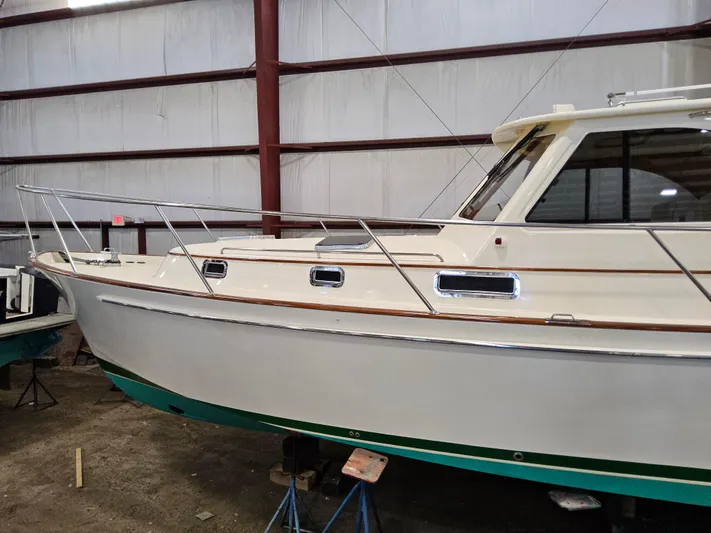 Lady One Yacht Photos Pics 2003 Legacy 40 Hardtop Express boat in indoor storage facility.