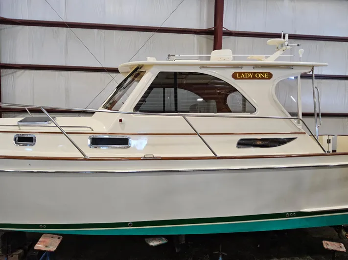 Lady One Yacht Photos Pics 2003 Legacy 40 Hardtop Express boat named "Lady One" in a storage facility.