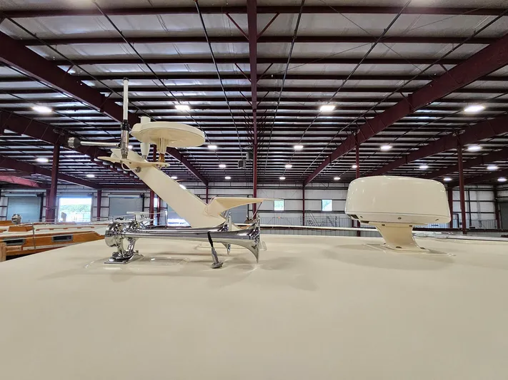 Lady One Yacht Photos Pics Rooftop equipment on 2003 Legacy 40 Hardtop Express boat in a warehouse setting.