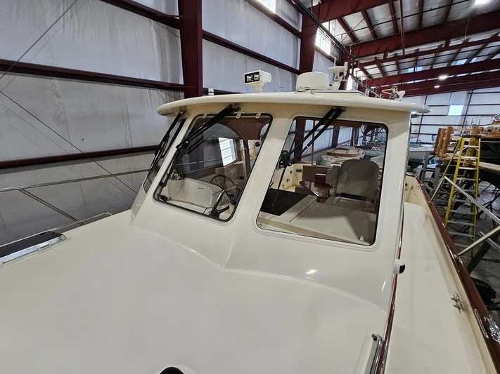 Lady One Yacht Photos Pics 2003 Legacy 40 Hardtop Express boat in indoor storage facility.