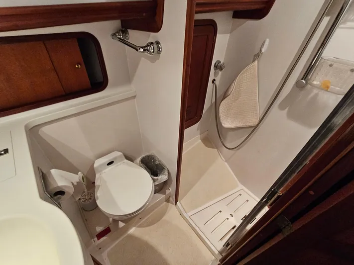 Lady One Yacht Photos Pics Bathroom interior of 2003 Legacy 40 Hardtop Express yacht, featuring toilet and shower.