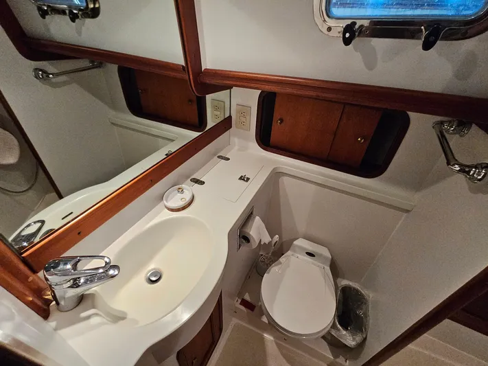 Lady One Yacht Photos Pics Bathroom interior of 2003 Legacy 40 Hardtop Express yacht, featuring sink and toilet.