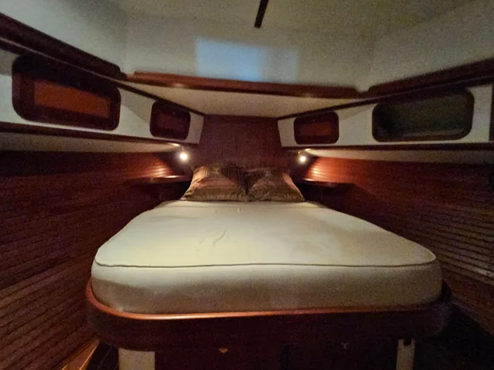 Lady One Yacht Photos Pics Cozy cabin interior of 2003 Legacy 40 Hardtop Express with wooden accents and comfortable bedding.