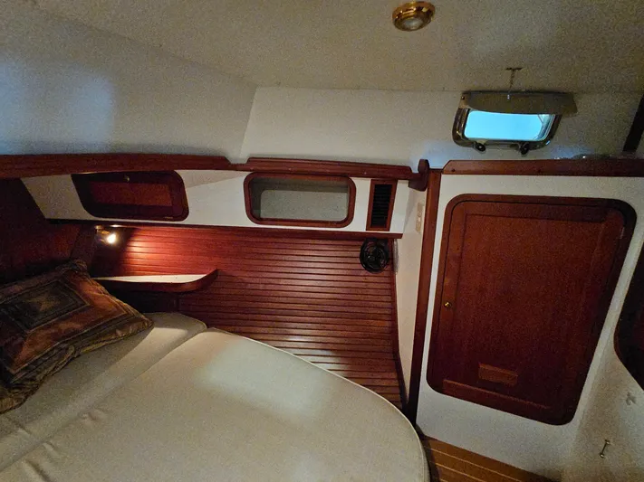 Lady One Yacht Photos Pics Cozy cabin interior of 2003 Legacy 40 Hardtop Express with wood paneling and porthole.