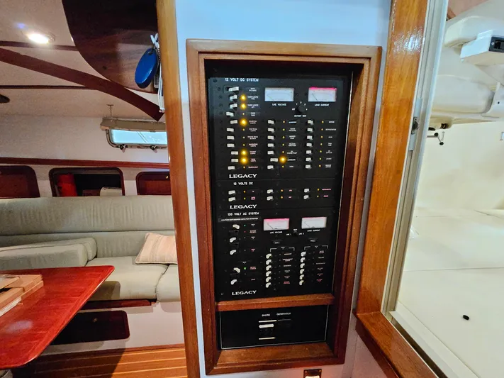Lady One Yacht Photos Pics Electrical panel inside 2003 Legacy 40 Hardtop Express yacht, featuring switches and meters.
