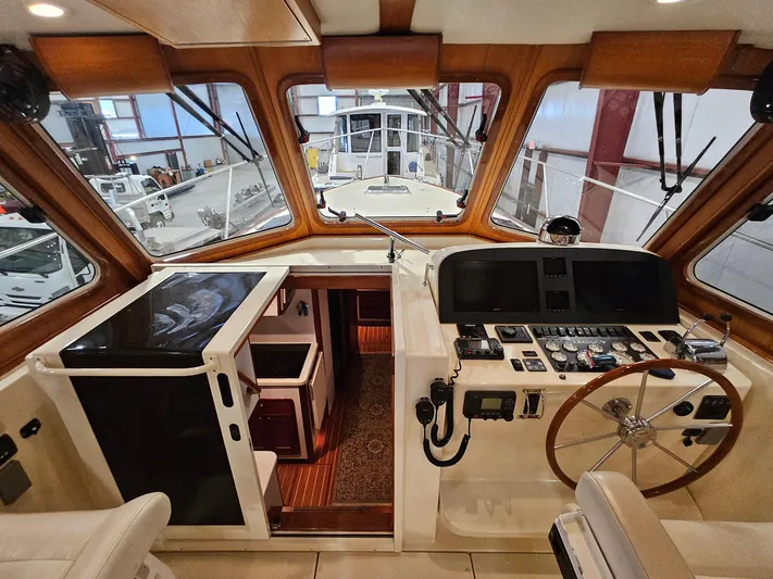 Lady One Yacht Photos Pics 2003 Legacy 40 Hardtop Express boat interior with navigation controls and wooden accents.