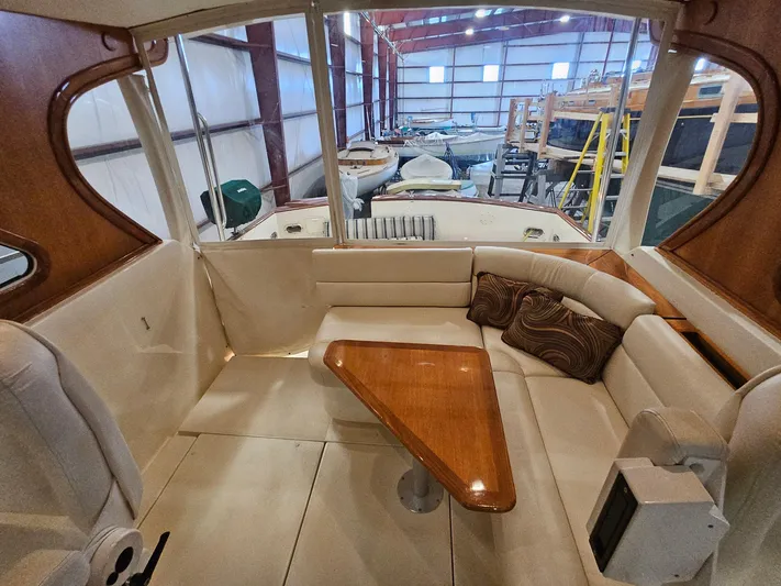 Lady One Yacht Photos Pics Interior of 2003 Legacy 40 Hardtop Express with seating and wooden table.
