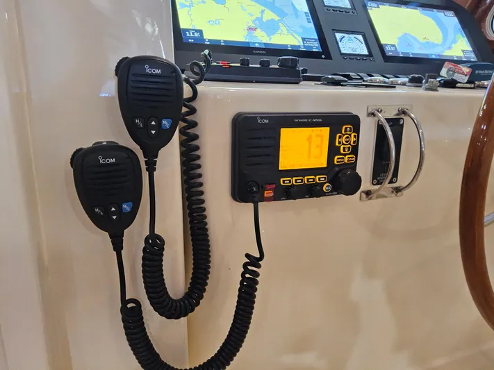 Lady One Yacht Photos Pics ICOM marine radio and microphones on a 2003 Legacy 40 Hardtop Express boat dashboard.