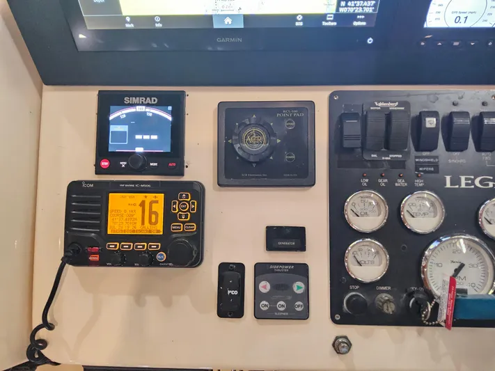 Lady One Yacht Photos Pics Control panel of a 2003 Legacy 40 Hardtop Express with navigation and communication instruments.