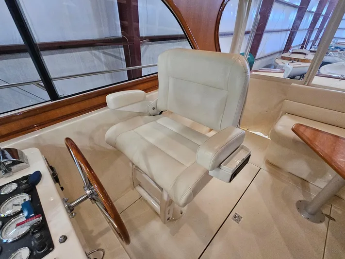 Lady One Yacht Photos Pics Captain's chair and helm of 2003 Legacy 40 Hardtop Express yacht interior.