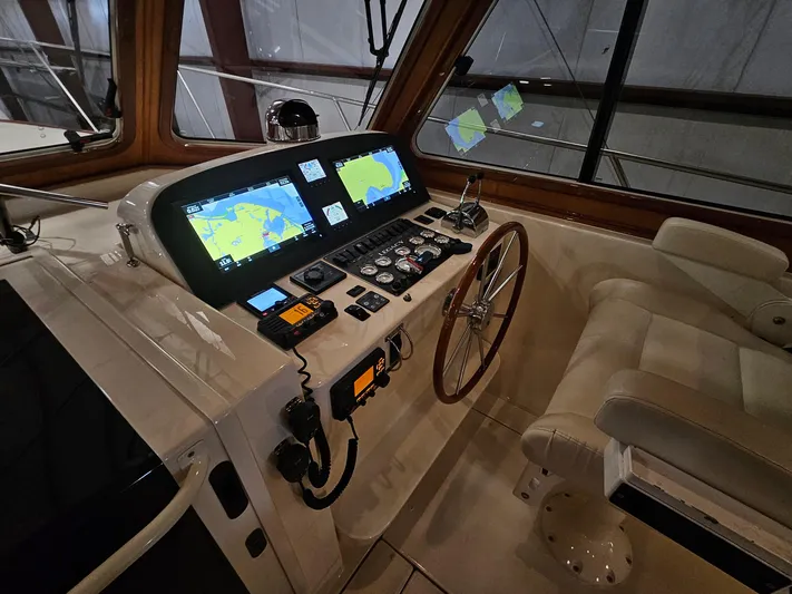 Lady One Yacht Photos Pics 2003 Legacy 40 Hardtop Express helm with navigation screens and controls.
