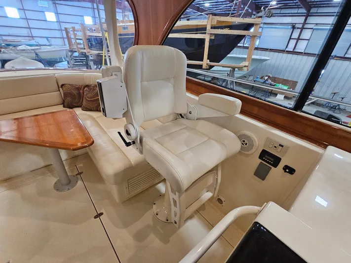 Lady One Yacht Photos Pics Captain's chair and seating area inside 2003 Legacy 40 Hardtop Express yacht.