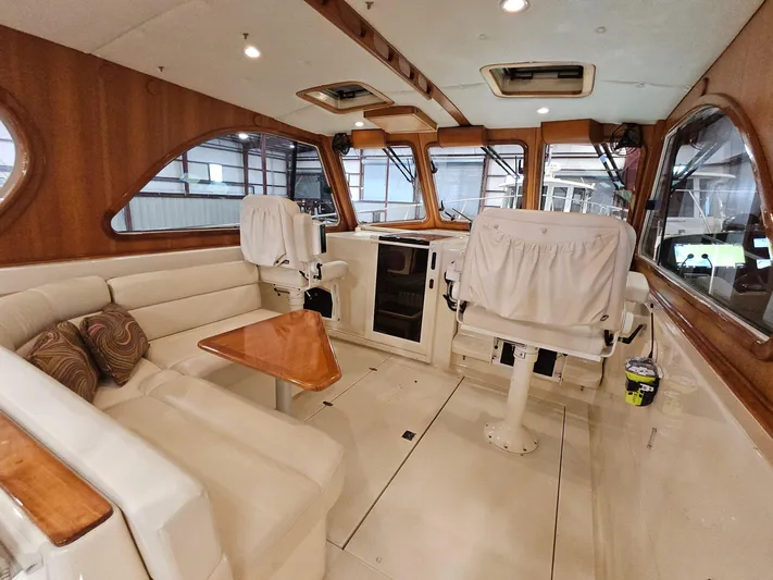 Lady One Yacht Photos Pics Interior of 2003 Legacy 40 Hardtop Express yacht with seating and helm station.