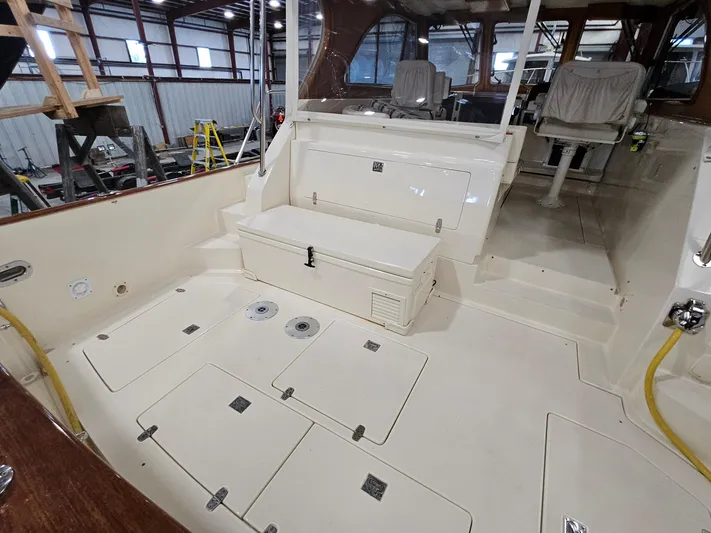 Lady One Yacht Photos Pics 2003 Legacy 40 Hardtop Express boat interior with seating and storage compartments.
