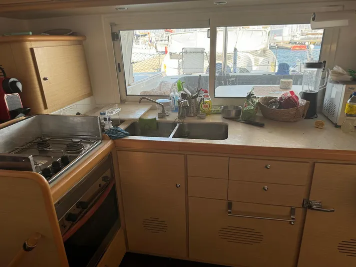  Yacht Photos Pics Galley kitchen in 2009 Lagoon 440 catamaran with stove, sink, and window view.