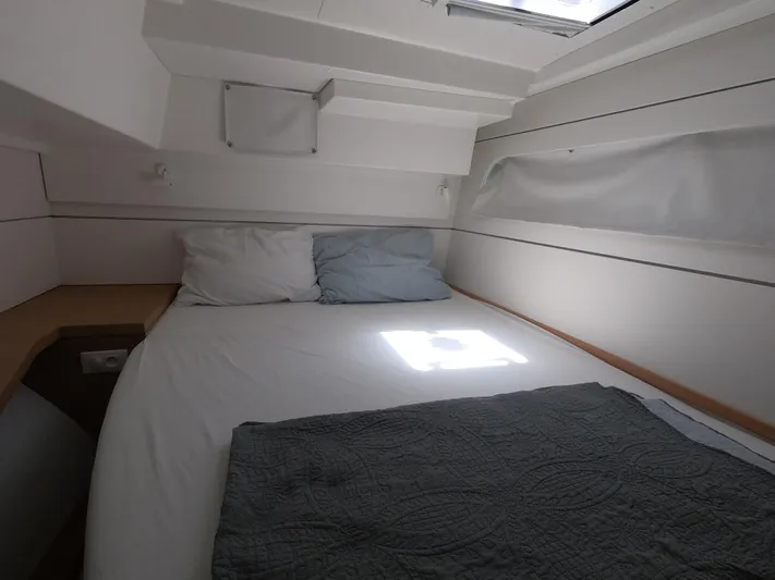  Yacht Photos Pics Cozy cabin interior of 2009 Lagoon 440 catamaran with bed and pillows.