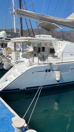  Yacht Photos Pics 2009 Lagoon 440 catamaran docked at marina, sunny day, clear blue water.