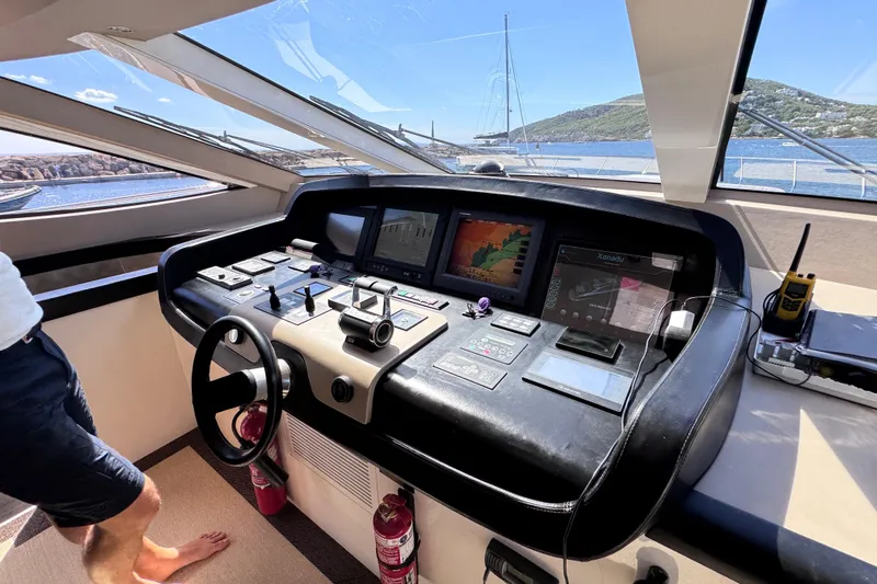  Yacht Photos Pics Helm of 2010 Canados 90 yacht with navigation controls and scenic ocean view.