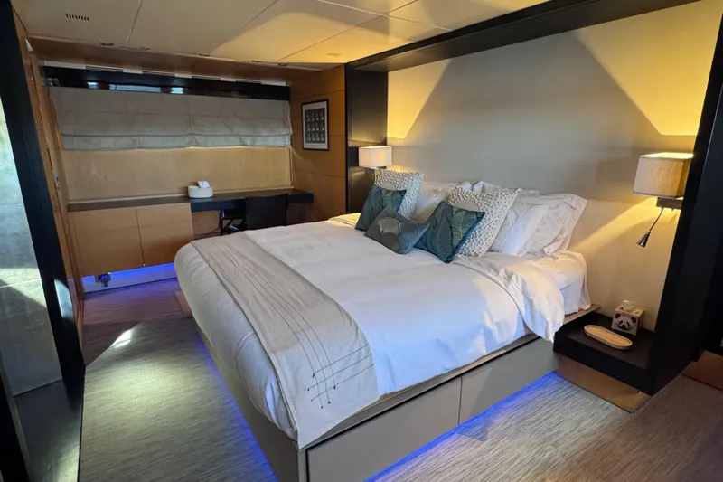  Yacht Photos Pics Luxurious bedroom interior on a 2010 Canados 90 yacht, featuring elegant bedding and ambient lighting.