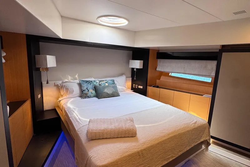  Yacht Photos Pics Luxurious bedroom interior on a 2010 Canados 90 yacht, featuring elegant decor and ambient lighting.