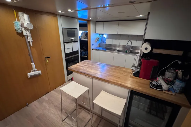 Yacht Photos Pics Modern kitchen interior on a 2010 Canados 90 yacht, featuring wooden countertops and sleek appliances.