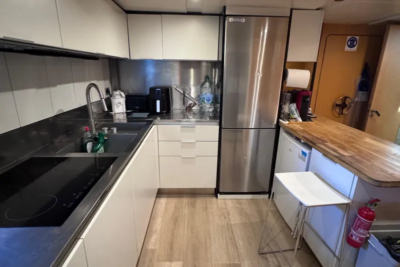  Yacht Photos Pics Modern kitchen interior on 2010 Canados 90 yacht, featuring sleek appliances and wooden accents.