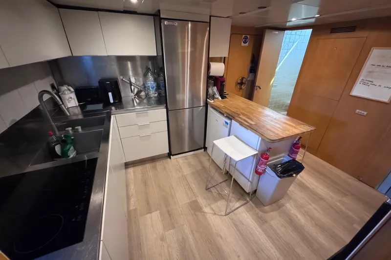  Yacht Photos Pics Modern kitchen interior on a 2010 Canados 90 yacht, featuring sleek appliances and wooden accents.