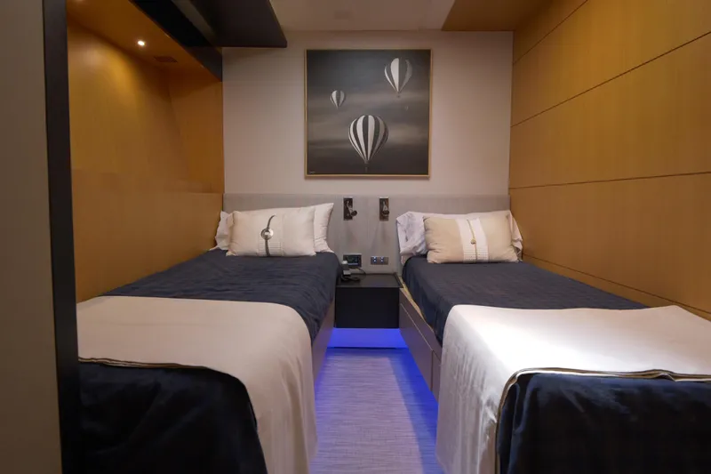  Yacht Photos Pics Luxurious twin cabin interior on 2010 Canados 90 yacht, featuring modern decor and ambient lighting.