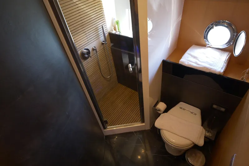  Yacht Photos Pics Luxurious bathroom on 2010 Canados 90 yacht with shower, toilet, and porthole window.