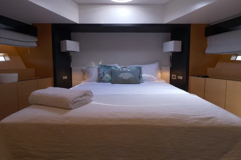  Yacht Photos Pics Luxurious bedroom interior on a 2010 Canados 90 yacht, featuring a cozy bed and elegant decor.