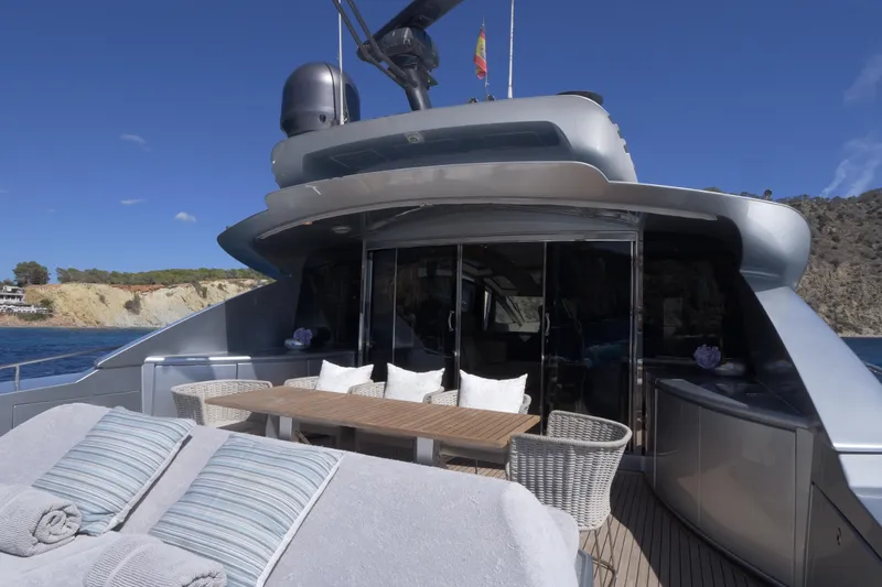  Yacht Photos Pics Luxurious 2010 Canados 90 yacht deck with seating and sunbathing area, coastal backdrop.