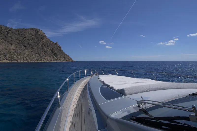  Yacht Photos Pics Luxury Canados 90 yacht cruising near rocky coastline under clear blue sky.