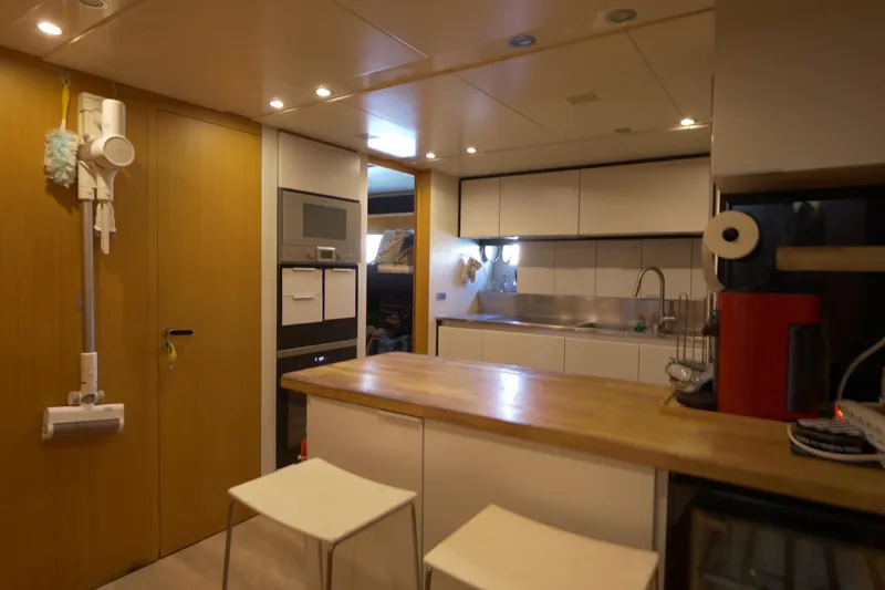  Yacht Photos Pics Modern kitchen interior on a 2010 Canados 90 yacht, featuring sleek cabinetry and wooden countertops.