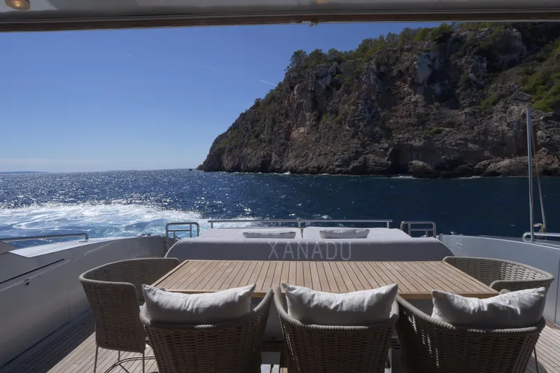  Yacht Photos Pics Luxury Canados 90 yacht deck with ocean view, 2010 model, near rocky coastline.