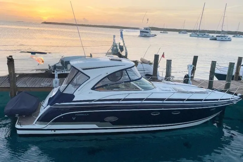Game Changer Yacht Photos Pics 2016 Formula 37 Performance Cruiser docked at sunset with other boats nearby.