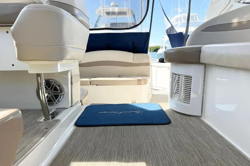 Game Changer Yacht Photos Pics 2016 Formula 37 Performance Cruiser interior with beige seating and blue mat.