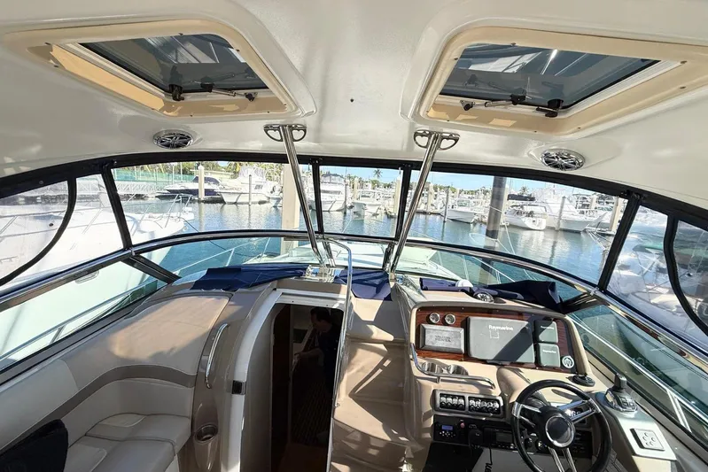 Game Changer Yacht Photos Pics Interior view of 2016 Formula 37 Performance Cruiser at marina, showcasing helm and seating area.