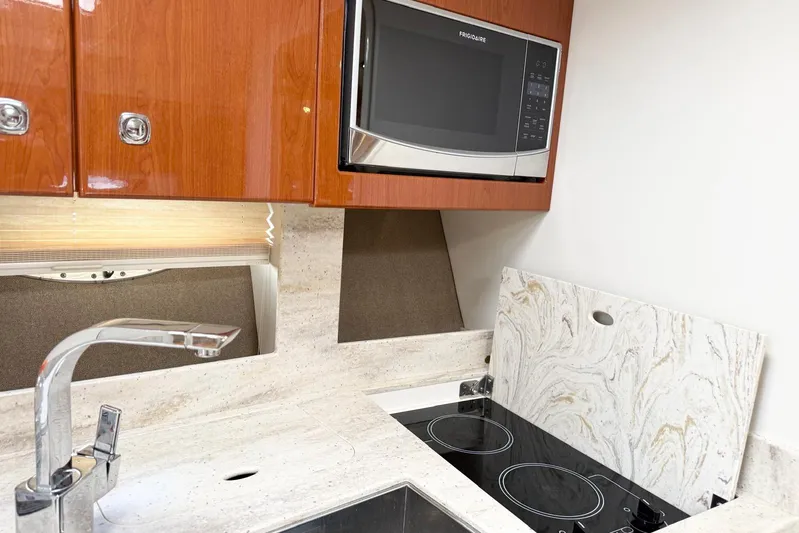 Game Changer Yacht Photos Pics 2016 Formula 37 Performance Cruiser kitchen with microwave, stove, and modern fixtures.