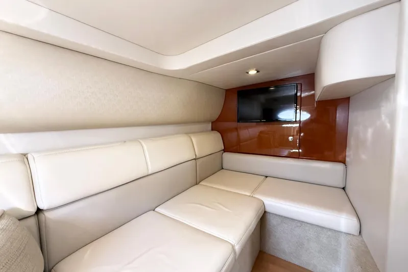 Game Changer Yacht Photos Pics Interior of 2016 Formula 37 Performance Cruiser with beige seating and wall-mounted TV.