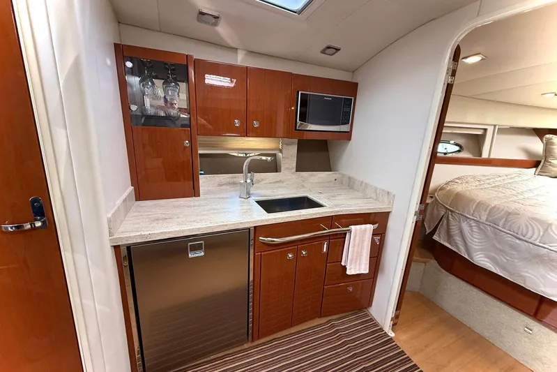 Game Changer Yacht Photos Pics 2016 Formula 37 Performance Cruiser interior with modern kitchenette and cozy bedroom.