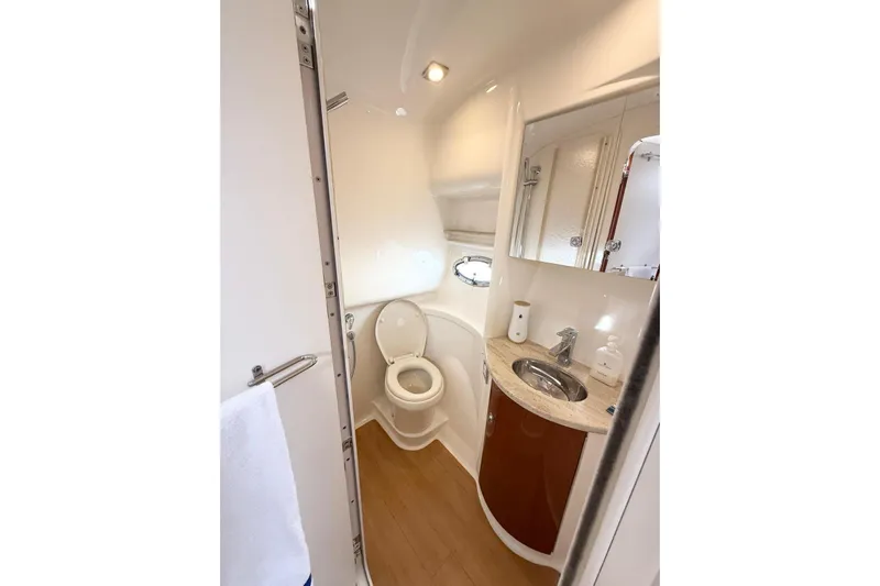 Game Changer Yacht Photos Pics 2016 Formula 37 Performance Cruiser bathroom with sink, toilet, and mirror.