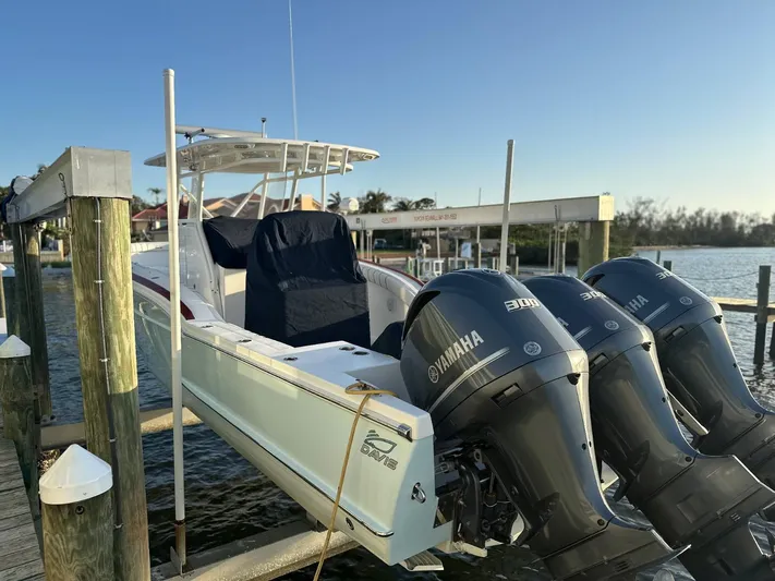  Yacht Photos Pics 2017 Custom Carolina Center Console boat with Yamaha engines docked by the water.